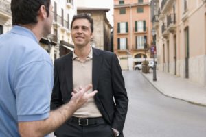 Two men talking on the street